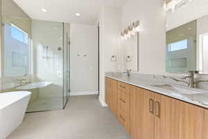 Bathroom featuring plus walk in shower and vanity