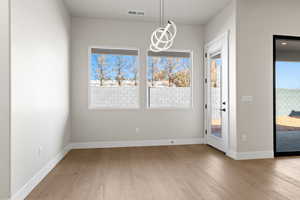 Unfurnished dining area featuring light hardwood / wood-style flooring