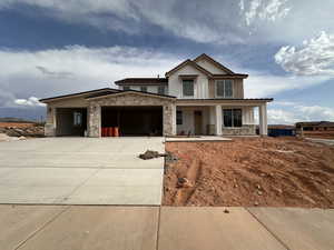 Modern farmhouse style home with stone siding, an attached garage, concrete driveway, covered porch, and board and batten siding