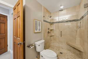 Bathroom featuring toilet and walk in shower