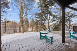 Snow covered deck featuring a mountain view