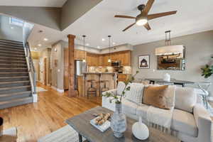 Living room featuring sink, ceiling fan, and light hardwood / wood-style flooring