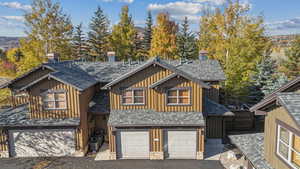 View of front facade featuring a garage and central AC unit