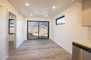 Unfurnished dining area featuring light hardwood / wood-style floors