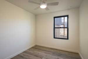 Spare room featuring ceiling fan and wood-type flooring