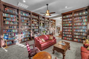 Sitting room with light carpet and ceiling fan