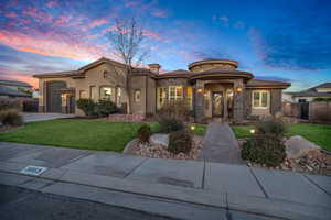 Mediterranean / spanish-style house featuring a garage and a yard