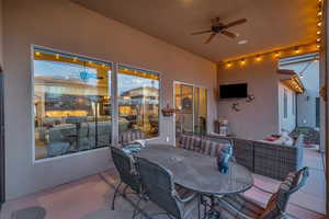 View of patio with an outdoor hangout area and ceiling fan