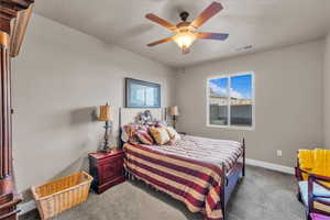 Bedroom featuring ceiling fan and carpet