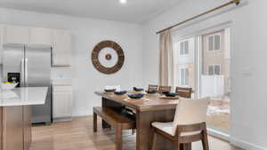 Dining area with light wood-type flooring