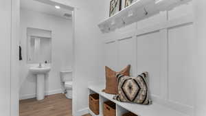 Mudroom featuring sink and hardwood / wood-style flooring