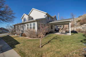 Exterior space featuring central AC, a lawn, and a patio area