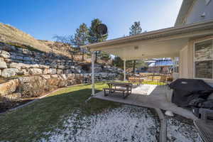 Exterior space with a patio area and a lawn