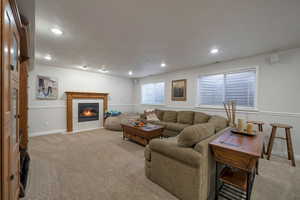 Carpeted living room with a tile fireplace