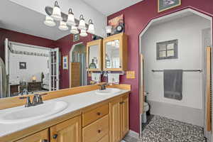 Bathroom featuring an inviting chandelier, vanity, and toilet