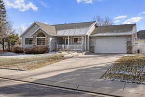 Single story home featuring a garage and covered porch