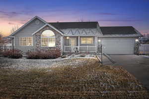 View of front of house featuring a garage and a porch