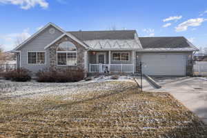 View of front of home with a garage and a porch