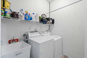 Laundry room featuring washer and clothes dryer and sink