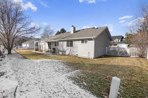 Back of property featuring a patio and a lawn