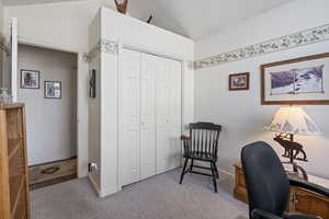 Carpeted office with vaulted ceiling