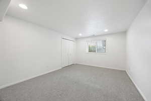 Spare room with carpet flooring and a textured ceiling