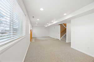 Basement featuring light colored carpet