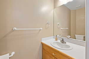 Bathroom featuring vanity and toilet