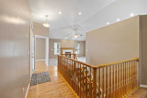 Hall featuring lofted ceiling and light hardwood / wood-style flooring