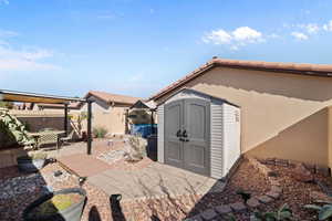 View of patio / terrace featuring a storage shed