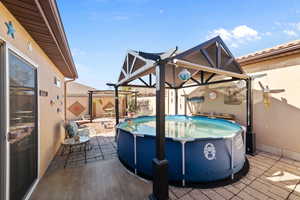 View of patio with a fenced in pool