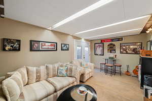 Living room with light carpet and french doors