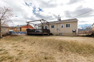 Back of property featuring a gazebo, a yard, and a deck