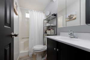 Bathroom with vanity, tile patterned flooring, and toilet