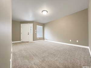 Spare room with light colored carpet