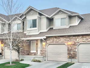 View of front facade featuring a garage