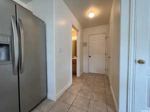 Hallway with light tile patterned floors