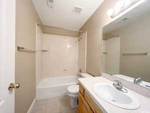 Full bathroom featuring tile patterned flooring, vanity, tub / shower combination, and toilet