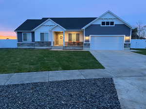 View of front of home featuring a garage and a lawn