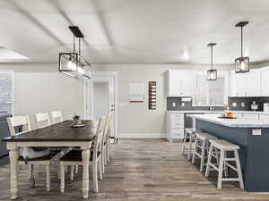 Dining area with sink and light hardwood / wood-style flooring