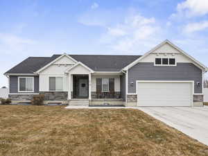 View of front of home with a garage and a front lawn