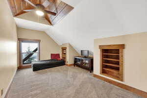 Carpeted bedroom with lofted ceiling