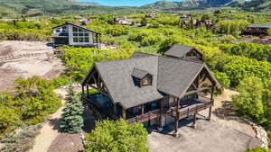 Aerial view of property and surrounding area with a mountainous background
