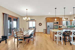 Dining room with an inviting chandelier and light wood-type flooring