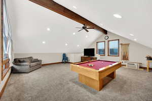 Game room with vaulted ceiling with beams, light colored carpet, and pool table