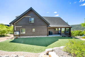 Rear view of house with a lawn