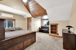 Bedroom with lofted ceiling, light colored carpet, wooden ceiling, and a wall unit AC