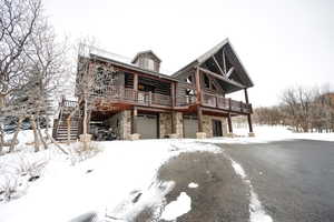 View of front of house featuring a garage and a deck