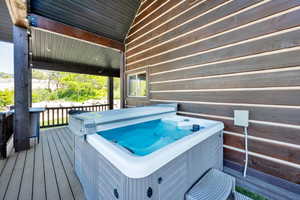 Wooden deck featuring a hot tub