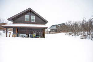 View of snow covered rear of property